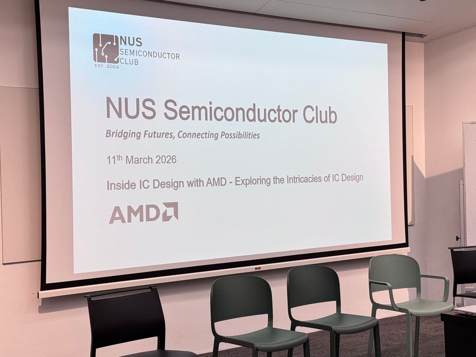 The title slide for the AMD IC design session projected in a seminar room before the audience arrived