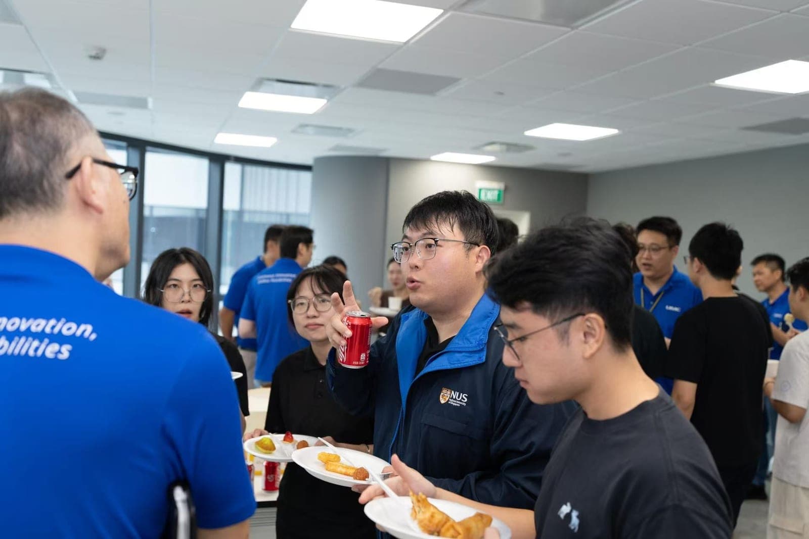 Students and UMC staff talking over refreshments during the site visit