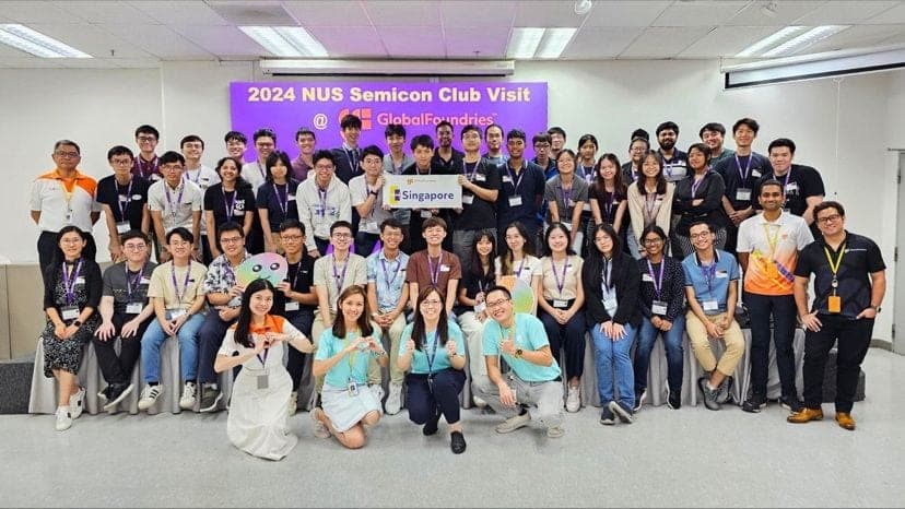 The visiting group photographed together under a screen reading 2024 NUS Semicon Club Visit at GlobalFoundries